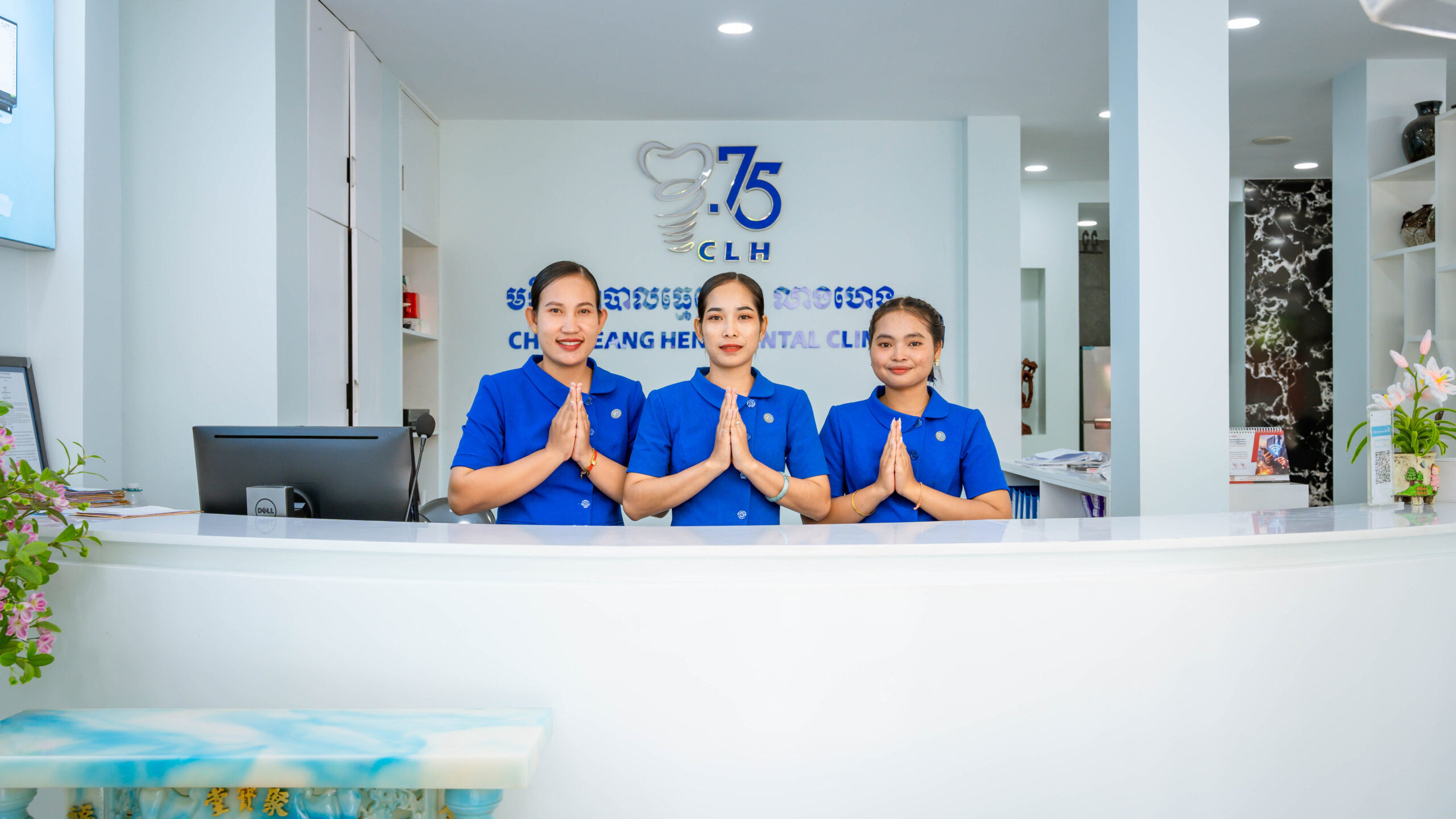 Receptionist welcoming patients at Chea Leangheng Dental Clinic II in Siem Reap, Cambodia